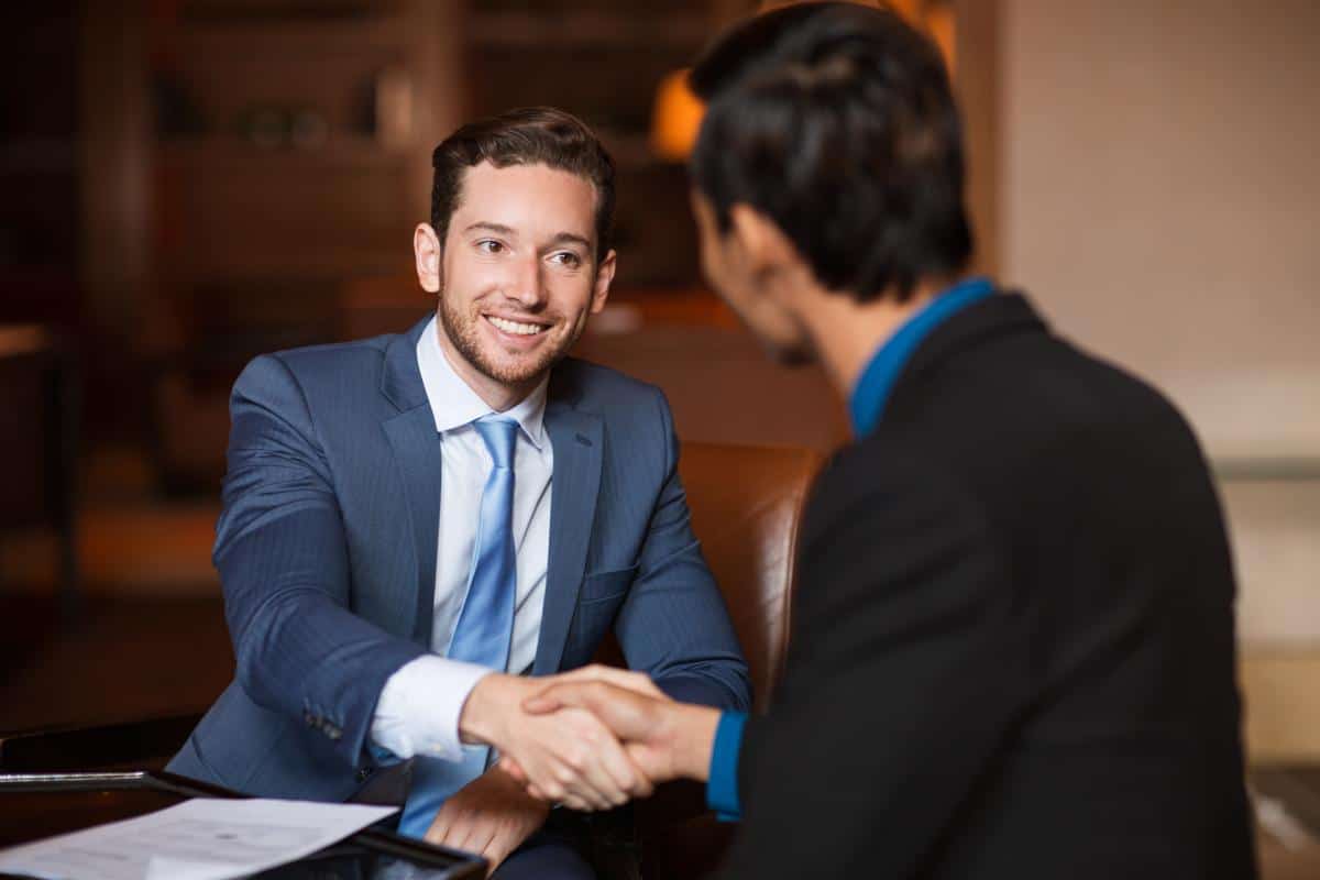 Smiling businessman shaking hands with a client