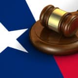 judge gavel laying on a texas flag graphic