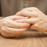 man removing wedding ring during divorce process