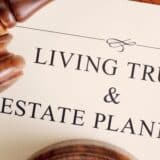 closeup of a living trust and estate planning document with a gavel sitting on the paper