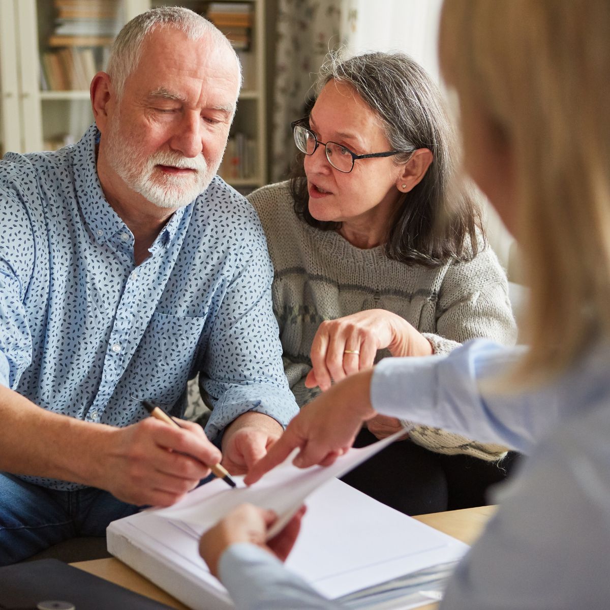 A senior couple reviewing documents together with a consultant