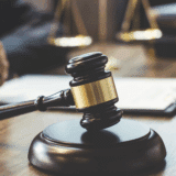 Close-up of a gavel and legal paperwork during a consultation about medical power of attorney rights and healthcare decisions.